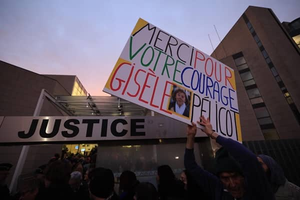 epa11784811 A woman holds a sign reading 'Thank you for your courage Gisele Pelicot' in front the criminal court before the Dominique Pelicot trial, in Avignon, South of France, 19 December 2024. Judges will hand down verdicts on 51 men in the mass rape trial in which Dominique Pelicot is accused of drugging and raping his then-wife, Gisele Pelicot as well as inviting dozens of men to rape her while she was unconscious at their home in Mazan, France, between 2011 and 2020.  EPA/GUILLAUME HORCAJUELO