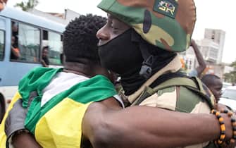 A joyful Gabonese embracing a Republican Guard soldier in front of the presidency in Port-Gentil (economic capital), on August 30, 2023 after the announcement of the Coup d'Etat perpetrated by the Gabonese Defense and Security Forces. President Ali Bongo Ondimba was deposed a few minutes after the announcement of his victory in the presidential elections of August 26, 2023. (Photo by: Desirey Minkoh/Afrikimages Agency/Universal Images Group via Getty Images)