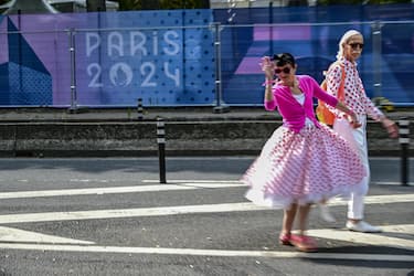 People walk near the Seine river amid the preparation for the opening veremony of the Paris 2024 Olympic Games in Paris , France , 24 j
July 2024.
ANSA / CIRO FUSCO