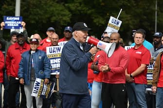 US President Joe Biden addresses striking members of the United Auto Workers (UAW) union at a picket line outside a General Motors Service Parts Operations plant in Belleville, Michigan, on September 26, 2023. Some 5,600 members of the UAW walked out of 38 US parts and distribution centers at General Motors and Stellantis at noon September 22, 2023, adding to last week's dramatic worker walkout. According to the White House, Biden is the first sitting president to join a picket line. (Photo by Jim WATSON / AFP) (Photo by JIM WATSON/AFP via Getty Images)