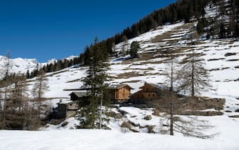 Snow-covered huts in the Mascognaz hamlet; Ayas; Champoluc; Aosta; Italy.