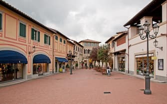 People shopping in McArthurGlen Barberino Designer Outlet arcade centre mall in Barberino di Mugello near Florence Tuscany Italy