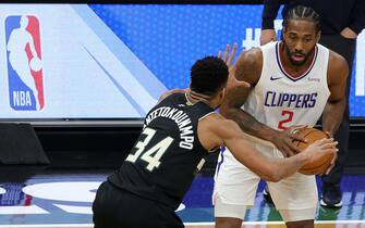 MILWAUKEE, WISCONSIN - FEBRUARY 28: Kawhi Leonard #2 of the LA Clippers is defended by Giannis Antetokounmpo #34 of the Milwaukee Bucks during the first half of a game at Fiserv Forum on February 28, 2021 in Milwaukee, Wisconsin. NOTE TO USER: User expressly acknowledges and agrees that, by downloading and or using this photograph, User is consenting to the terms and conditions of the Getty Images License Agreement. (Photo by Stacy Revere/Getty Images)