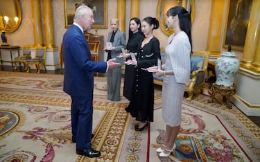 King Charles III with presents the members of the K-Pop band Blackpink (left to right) Rose (Roseanne Park), Jisoo Kim, Jennie Kim, and Lisa (Lalisa Manoban), with Honorary MBEs (MBE (Member of the Order of the British Empire) during a special investiture ceremony in the presence of the President of South Korea, Yoon Suk Yeol, and his wife, Kim Keon Hee, at Buckingham Palace, London. Picture date: Wednesday November 22, 2023.