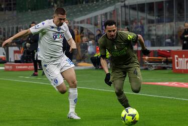 AC Milan's midfielder Ismael Bennacer in action against Empoli FC's midfielder Razvan Marin during the Italian Serie A soccer match between AC Milan and Empoli FC at Giuseppe Meazza stadium in Milano, Italy, 7 April 2023. ANSA / ROBERTO BREGANI