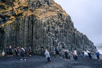 The Reynisfjara black-sand beach is seen on the south coast near Vik, Iceland on December 17, 2018. The Atlantic Oceans waves are seen crashing into enormous basalt stacks.  (Photo by Patrick Gorski/NurPhoto via Getty Images)