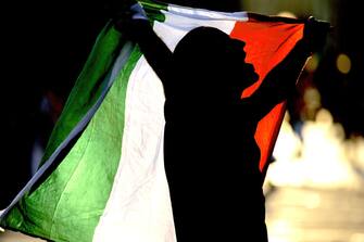 An Italian fan waves his flag after World Cup 2006 soccer match between  Australia and Italy in downtown Milan, 26 June 2006. Real worldcup fever is now rising in the country as Italy reaches the World Cup quarter-finals after beating Australia 1-0.  
     AFP PHOTO / Filippo MONTEFORTE (Photo by Filippo MONTEFORTE / AFP) (Photo by FILIPPO MONTEFORTE/AFP via Getty Images)