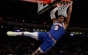 NEW YORK, NEW YORK - MARCH 16: RJ Barrett #9 of the New York Knicks hangs on the basket after dunking during the second half against the Portland Trail Blazers at Madison Square Garden on March 16, 2022 in New York City. The Knicks won 128-98. NOTE TO USER: User expressly acknowledges and agrees that, by downloading and or using this photograph, User is consenting to the terms and conditions of the Getty Images License Agreement. (Photo by Sarah Stier/Getty Images)