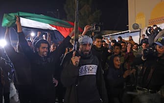 People celebrate along a street in Khan Yunis in the southern Gaza Strip on January 15, 2025, amid the ongoing war in the Palestinian territory between Israel and Hamas. Thousands of Gazans celebrated on January 15 as news spread that a ceasefire and hostage release deal had been reached between Israel and Hamas, aimed at ending more than 15 months of war in the Palestinian territory. (Photo by BASHAR TALEB / AFP)