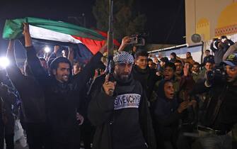Persone festeggiano in strada a Gaza per l'accordo fra Israele e Hamas People celebrate along a street in Khan Yunis in the southern Gaza Strip on January 15, 2025, amid the ongoing war in the Palestinian territory between Israel and Hamas. Thousands of Gazans celebrated on January 15 as news spread that a ceasefire and hostage release deal had been reached between Israel and Hamas, aimed at ending more than 15 months of war in the Palestinian territory. (Photo by BASHAR TALEB / AFP)