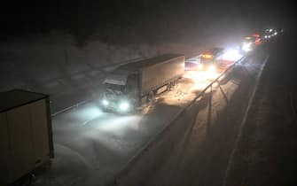 Vehicles are stuck on the European route E22 at Ekeroed near Hoerby in southern Sweden on January 3, 2024. Strong winds and drifting snow have caused several traffic accidents in the area. Emergency services and the defence force deploy tracked vehicles to evacuate people who have been stuck in their cars for hours. Sweden on January 3 recorded its coldest January night in 25 years, with a reading of minus 43.6 degrees Celsius in the far north as a cold snap hit the Nordics. (Photo by Johan NILSSON / TT News Agency / AFP) / Sweden OUT (Photo by JOHAN NILSSON/TT News Agency/AFP via Getty Images)