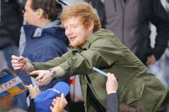 NEW YORK, NY - MARCH 08:  Ed Sheeran signs an autograph for a fan  when he performs on NBC's "Today Show" at Rockefeller Plaza on March 8, 2017 in New York City.  (Photo by Al Pereira/WireImage)