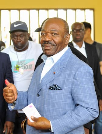 epa10828169 Gabonese President Ali Bongo Ondimba Shows his inked thumb after casting his vote during the 2023 Gabonese general elections in Libreville, Gabon, 26 August 2023 (reissued 30 August 2023). Members of the Gabonese army announced 30 Augsut 2023 that they had ended Gabonese President Ali Bongo's regime as they spoke on national television.  EPA/STR