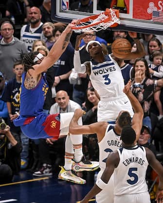 DENVER, CO - MAY 4: Aaron Gordon (50) of the Denver Nuggets dunks over Jaden McDaniels (3) Rudy Gobert (27) and Anthony Edwards (5) of the Minnesota Timberwolves during the first quarter at Ball Arena in Denver on Saturday, May 4, 2024. (Photo by AAron Ontiveroz/The Denver Post)