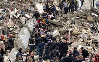 ADANA, TURKIYE - FEBRUARY 06: A person is rescued from the wreckage of a building during search and rescue efforts after a 7.4 magnitude earthquake hit southern provinces of Turkiye, in Adana, Turkiye on February 6, 2023. The 7.4 magnitude earthquake jolted Turkiyeâs southern province of Kahramanmaras early Monday, according to Turkiyeâs Disaster and Emergency Management Authority (AFAD). It was followed by a magnitude 6.4 quake that struck southeastern Gaziantep province. A third earthquake with a 6.5 magnitude also hit Gaziantep. Earthquakes had affected several provinces including, Osmaniye, Malatya, Adiyaman, Adana, Diyarbakir, Kilis and Sanliurfa. (Photo by Eren Bozkurt/Anadolu Agency via Getty Images)