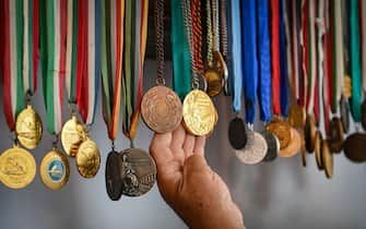 Vasile Diba, 66, former kayak Olympic champion at Montreal in 1976, shows his Olympic medals at his place in the village of Jurilovca, Romania, on June 22, 2021. - Diba was born in Jurilovca, once a fishermen village, located in the south area of Danube's Delta. Diba does not hide his pessimism; the Romanian chances of returning to the world elite are "zero", he says. Mila 23 -- a fishing hamlet of some 450 people in the heart of the Danube Delta -- has brought forth dozens of canoe champions.
But it is running out of steam, raising concerns for the future of a sport that has brought Romania a stream of Olympic medals. (Photo by Daniel MIHAILESCU / AFP) (Photo by DANIEL MIHAILESCU/AFP via Getty Images)