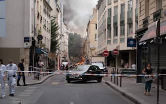 Smoke billows from rubbles of a building at Place Alphonse-Laveran in the 5th arrondissement of Paris, on June 21, 2023. A major fire of unknown origin broke out on June 21, 2023 in a building in central Paris, part of which collapsed, injuring at least one person, according to sources and AFP images. (Photo by ABDULMONAM EASSA / AFP) (Photo by ABDULMONAM EASSA/AFP via Getty Images)