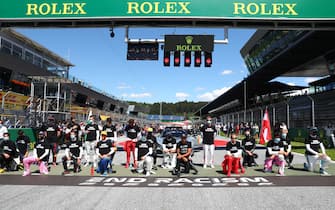 Drivers kneel behind a banner reading "End racism" ahead the Austrian Formula One Grand Prix race on July 5, 2020 in Spielberg, Austria in solidarity with the "Black Lives Matter" movement. (Photo by Dan ISTITENE / POOL / AFP) (Photo by DAN ISTITENE/POOL/AFP via Getty Images)