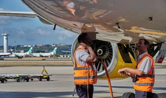 LISBON, PORTUGAL - AUGUST 31: Groundforce ramp service personnel check a Vueling Airbus A321 ready to depart in Humberto Delgado International Airport on August 31, 2022 in Lisbon, Portugal. The city's airport has returned to normal after the forced inactivity due to the COVID-19 Coronavirus pandemic, and large numbers of travelers meant delays and recriminations from the government to SEF and ANA, in charge of handling departing and arriving passengers. INE attributes to the strong recovery dynamics in tourism an important part of the country's economic growth. Compared to the first quarter of 2021 -when Portugal was practically paralyzed by the pandemic- domestic demand increased by 9.8%, exports by 18.3%, and imports by 13.1%. Portugal's economy grew 2.6% in the first quarter compared to the last one of 2021 -and 11.9% compared to the same period of the previous year, thanks to the end of COVID-19 Coronavirus restrictions and a strong growth in private consumption. (Photo by Horacio Villalobos#Corbis/Corbis via Getty Images)