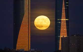A blue supermoon rises beyond skyscraper office buildings in the Cuatro Torres business district in Madrid, Spain, on Wednesday Aug. 30, 2023. Spanish inflation quickened again in the first of a string of reports from around the region that will help European Central Bank officials judge whether to keep raising interest rates. Photographer: Paul Hanna/Bloomberg via Getty Images