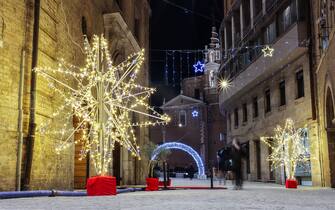 Ancona, Italy - January 14, 2022: Via della Loggia in Ancona is the ancient via del Porto, overlooked by buildings that have seen the history of the seafaring city, including the Loggia dei Mercanti and the Palazzo Benincasa. Via della Loggia (Ancona, Marche) with Christmas lights.