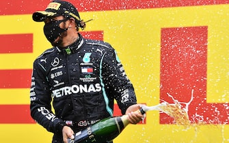 SPIELBERG, AUSTRIA - JULY 12: Lewis Hamilton of Great Britain and Mercedes GP celebrates on the podium after winning the Formula One Grand Prix of Styria at Red Bull Ring on July 12, 2020 in Spielberg, Austria. (Photo by Joe Klamar/Pool via Getty Images)