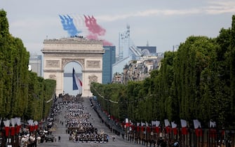French Air Force elite acrobatic flying team "Patrouille de France" (PAF) performs a fly-over during the Bastille Day military parade on the Champs-Elysees avenue, with the Arc de Triomphe seen in the foreground, in Paris on July 14, 2023. (Photo by Ludovic MARIN / AFP) (Photo by LUDOVIC MARIN/AFP via Getty Images)