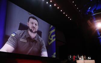 epa09953464 Ukraine's President Volodymyr Zelensky appears via remote on a screen during the Opening Ceremony of the 75th annual Cannes Film Festival, in Cannes, France, 17 May 2022. The festival runs from 17 to 28 May.  EPA/GUILLAUME HORCAJUELO