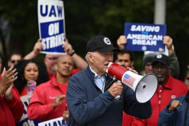 US President Joe Biden addresses striking members of the United Auto Workers (UAW) union at a picket line outside a General Motors Service Parts Operations plant in Belleville, Michigan, on September 26, 2023. Some 5,600 members of the UAW walked out of 38 US parts and distribution centers at General Motors and Stellantis at noon September 22, 2023, adding to last week's dramatic worker walkout. According to the White House, Biden is the first sitting president to join a picket line. (Photo by Jim WATSON / AFP) (Photo by JIM WATSON/AFP via Getty Images)