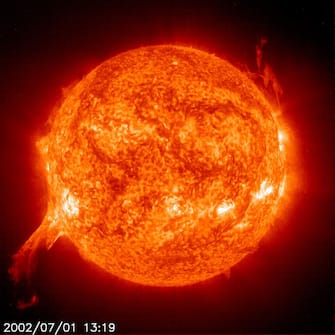 IN SPACE - JULY 1:  A solar eruption from the sun is shown from an image by NASA's SOHO satellite July 1, 2002. Scientists call the solar eruption a prominence which is a huge cloud of relatively cool, dense plasma suspended in the sun's corona with magnetic fields building up enormous forces that propel particles out beyond the sun's surface. The blasts occur about every eleven years for 3 to 4 days and can affect the Earth.  (Photo by NASA/Getty Images) 