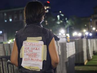 NEW YORK, UNITED STATES - APRIL 30: A student of Columbia University advocating for Palestinians, stick a banner on her back as students access the iconic Hamilton Hall building while they gather to stage a demonstration at the campus in New York, United States on April 30, 2024. Protests are sweeping college campuses across the US following a police attempt to clear a pro-Palestinian encampment at Columbia University, resulting in the arrest of over 100 students. Columbia University asked students on Monday to 'voluntarily disperse' amid stalled talks, threatening the students with suspension. (Photo by Selcuk Acar/Anadolu via Getty Images)