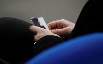 Rosa Maria Esilio, widow of Italian Carabinieri paramilitary police officer Mario Cerciello Rega, holds a photograph of her husband ahead of a hearing in the trial in which two American tourists are accused of killing Rega in Rome, Thursday, Dec. 17, 2020. Finnegan Lee Elder and Gabriel Natale-Hjorth both from California are accused of murdering the police officer during a summer vacation in Italy in July 2019. (AP Photo/Gregorio Borgia, Pool)