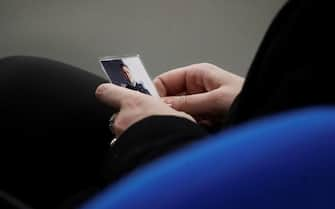 Rosa Maria Esilio, widow of Italian Carabinieri paramilitary police officer Mario Cerciello Rega, holds a photograph of her husband ahead of a hearing in the trial in which two American tourists are accused of killing Rega in Rome, Thursday, Dec. 17, 2020. Finnegan Lee Elder and Gabriel Natale-Hjorth both from California are accused of murdering the police officer during a summer vacation in Italy in July 2019. (AP Photo/Gregorio Borgia, Pool)