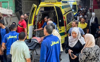 Paramedics prepare a gurney to receive a victim at the scene of a building collapse in the Hadayiq al-Qubba district of Cairo on July 17, 2023. (Photo by Ahmed HASAN / AFP) (Photo by AHMED HASAN/AFP via Getty Images)