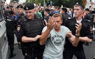 TOPSHOT - Opposition leader Alexei Navalny (C) is detained by Russian police officers during a march to protest against the alleged impunity of law enforcement agencies in central Moscow on June 12, 2019. - More than 50 people including opposition leader Alexei Navalny were detained as police sought to break up a peaceful Moscow rally against the alleged impunity of law enforcement agencies. The unsanctioned rally was initially called to press for the freedom of investigative journalist Ivan Golunov who was last week arrested on trumped-up drugs charges but released on the eve of the march. (Photo by Vasily MAXIMOV / AFP)        (Photo credit should read VASILY MAXIMOV/AFP via Getty Images)