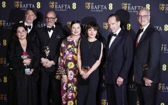 epa11901930 (L-R) Tessa Ross, Peter Straughan, Edward Berger, Isabella Rossellini, Juliette Howell, Ralph Fiennes and Michael Jackman pose in the press room with the Best Film award for 'Conclave' during the BAFTA Film Awards at the Royal Festival Hall in London, Britain, 16 February 2025. The ceremony is hosted by the British Academy of Film and Television Arts (BAFTA).  EPA/TOLGA AKMEN