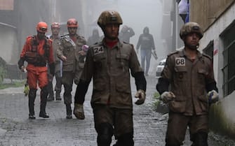 Members of the Civil Defense, firefighters and neighbours work to rescue victims in a zone affected by heavy rains in Petropolis, Brazil on March 23, 2024. At least nine people died in the midst of a strong storm that hits the southeast of Brazil, particularly the mountain area of the state of Rio de Janeiro, where authorities deployed a strong operation this Saturday in the face of a "critical" situation. The authorities reported three deaths in the collapse of a house in the city of Petropolis, about 70 kilometers from the capital of Rio, in a bulletin issued by an emergency committee formed by the government of Rio together with the Fire and Defense forces. (Photo by Pablo PORCIUNCULA / AFP) (Photo by PABLO PORCIUNCULA/AFP via Getty Images)