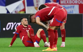 epa11416234 Filip Kostic of Serbia sits injured on the pitch  during the UEFA EURO 2024 group C match between Serbia and England in Gelsenkirchen, Germany, 16 June 2024.  EPA/CHRISTOPHER NEUNDORF