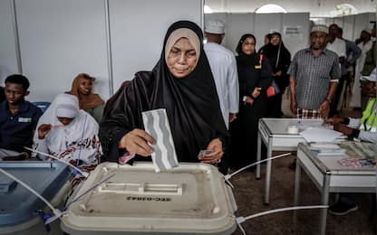 A voter casts her ballot while others queue at the Maundi voting centre in Stone Town on October 29, 2025, during Tanzania's presidential elections. Polls opened on October 29, 2025 in Tanzania elections in which the main challengers were either jailed or barred from running, with rights groups decrying a "wave of terror".
President Samia Suluhu Hassan, 65, is determined to cement her position with an emphatic victory that will silence critics within her own party, analysts say. (Photo by Marco Longari / AFP)
