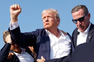 BUTLER, PENNSYLVANIA - JULY 13: Republican presidential candidate former President Donald Trump is rushed offstage during a rally on July 13, 2024 in Butler, Pennsylvania. (Photo by Anna Moneymaker/Getty Images)