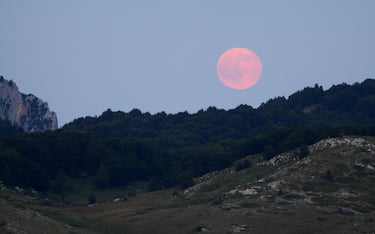The pink full moon rises over Gran Sasso Laga National Park, July 2015.