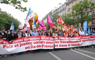 epa11312332 French trade union leaders carry a banner during the annual  May Day march in Paris, France, 01 May 2024. Unions in France are demanding improved living conditions, higher wages, the defense of public services and a just and lasting peace.  EPA/Teresa Suarez