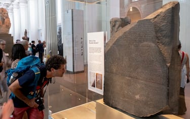 Visitors looking at the Rosetta Stone at the British Museum on 24th August 2022 in London, United Kingdom. The British Museum is a public museum dedicated to human history, art and culture located in the Bloomsbury area of London. It has a permanent collection of eight million works and is among the largest and most comprehensive collection, which documents the story of human culture from its beginnings to the present. (photo by Mike Kemp/In Pictures via Getty Images)