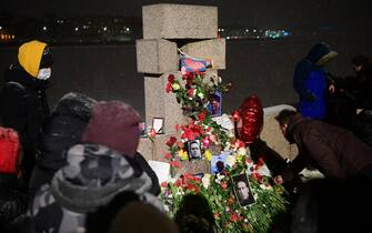 People gather at a makeshift memorial for late Russian opposition leader Alexei Navalny organized at the monument to the victims of political repressions in Saint Petersburg on February 16, 2024, following Navalny's death in his Arctic prison. (Photo by Olga MALTSEVA / AFP)