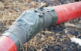 close up red pipe on the ground