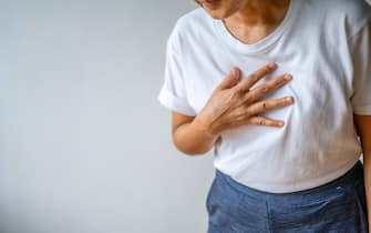 Woman suffering from chest pain heart attack. Healthcare and medical concept.