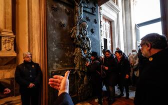 Pilgrims pass the Holy Door of St Giovanni's Basilica, in Rome, Italy, 29 December 2024. ANSA/GIUSEPPE LAMI