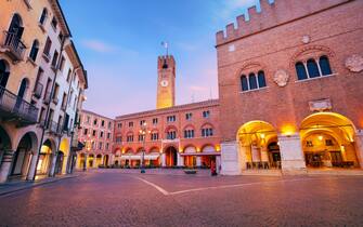 Cityscape image of historical center of Treviso, Italy with old square at sunrise.