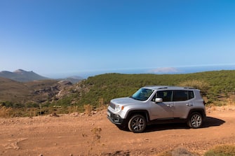 Vacation with a rental car. 4x4 off-road Jeep Renegade on dirt road on Rhodes island. Greece. October 09, 2022