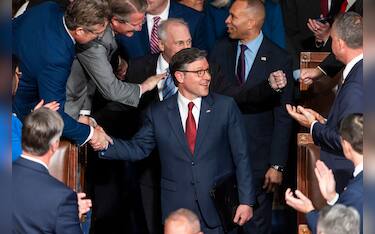 epa11804173 Republican Speaker of the House Mike Johnson (C) greets lawmakers as he re-enters the House chamber after winning the votes to maintain his position as Speaker of the House at the start of the 119th Congress in the US Capitol in Washington, DC, USA, 03 January 2025. The US House of Representatives begins its 119th session with an election for the next Speaker of the House, followed by a swearing-in for all members.  EPA/JIM LO SCALZO